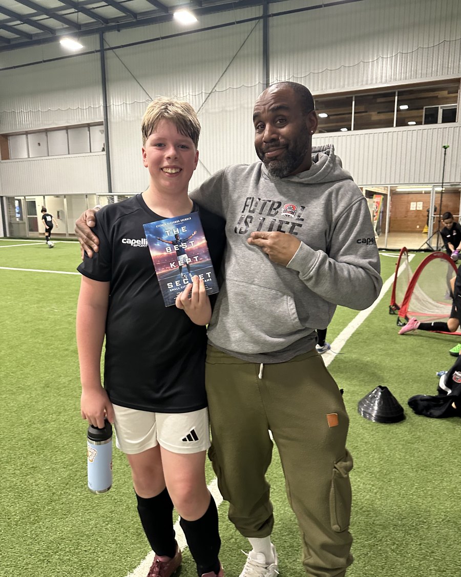 A young CT² player holding his copy of The Best Kept Secret with Stephen Ademolu